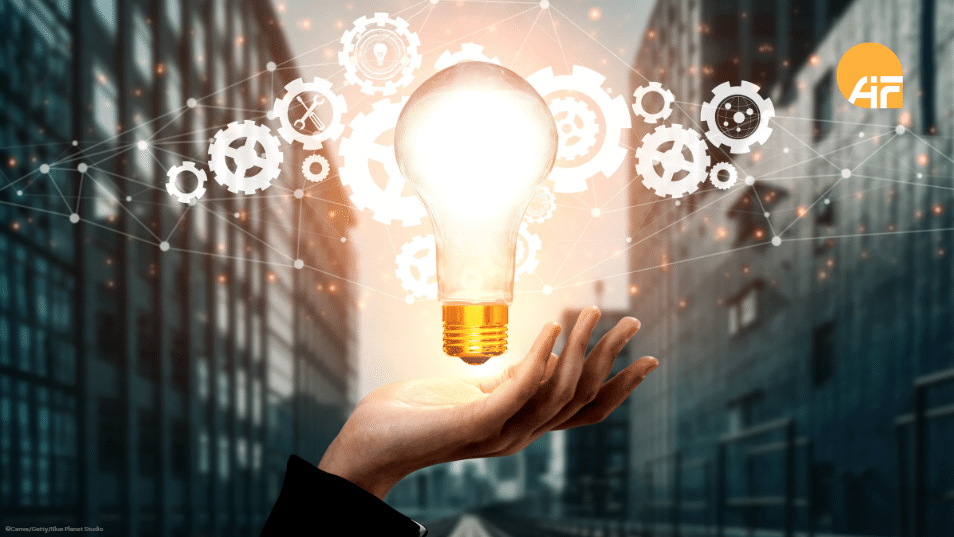 Eine Hand mit einer leuchtenden Glühbirne.